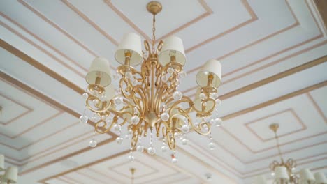 a ceiling decorated by chandelier, close up shot