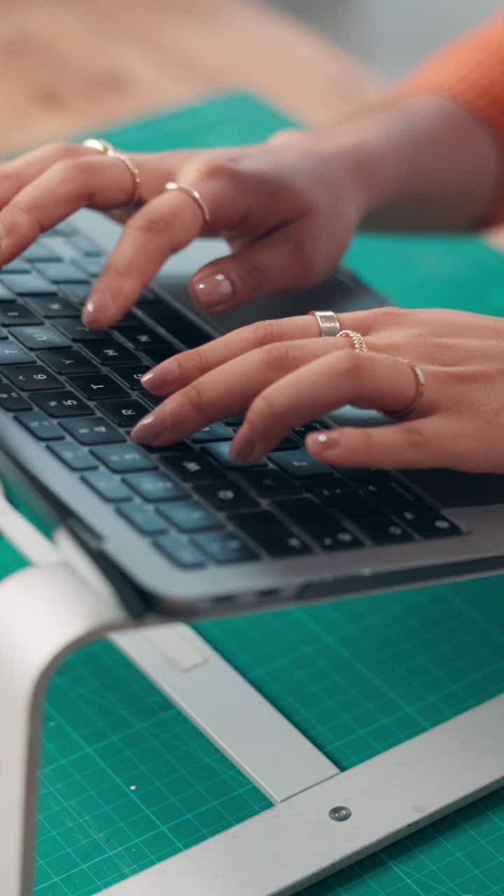 Woman's Hands Typing on Laptop Keyboard at Desk