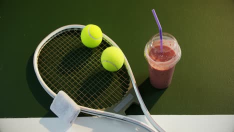 Milkshake-and-sports-equipment-in-tennis-court-4k