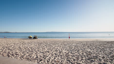 Buggy-De-Salvavidas-En-La-Orilla-De-La-Playa-De-Arena-Junto-Al-Océano-Azul-Plano-A-La-Luz-De-La-Mañana,-Cámara-Lenta-De-4k