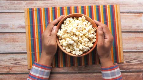 person enjoying a bowl of popcorn