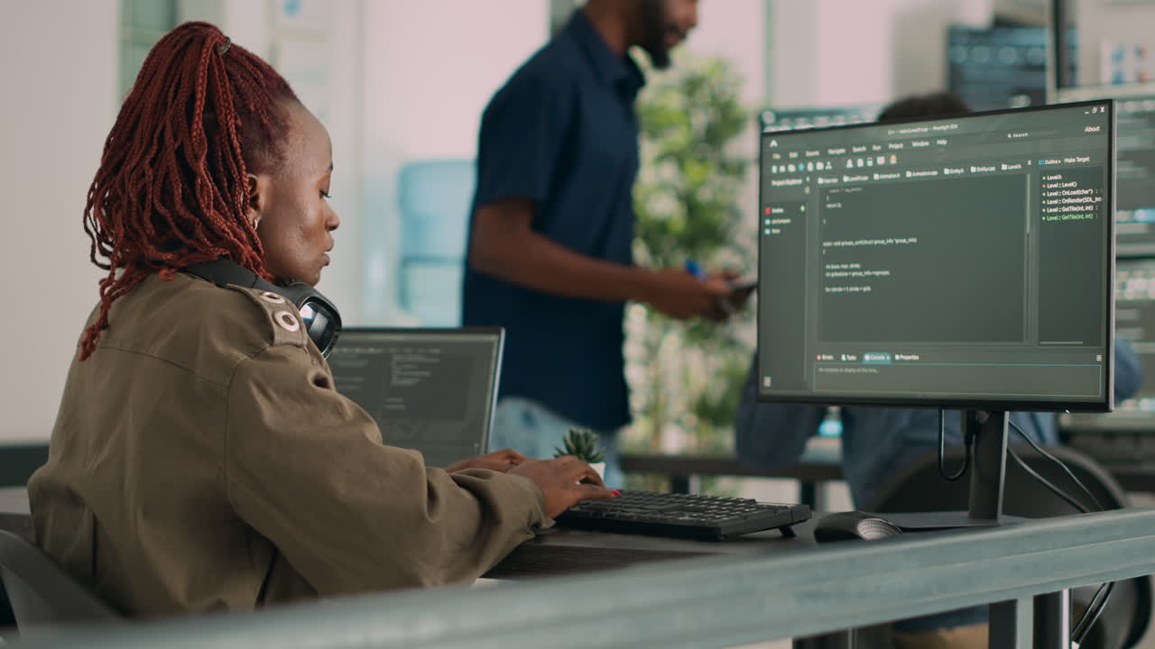 Software developer typing programming code on computer