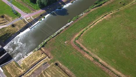 Aerial-tilt-down-shot-of-water-coming-out-from-a-dam-in-Poland