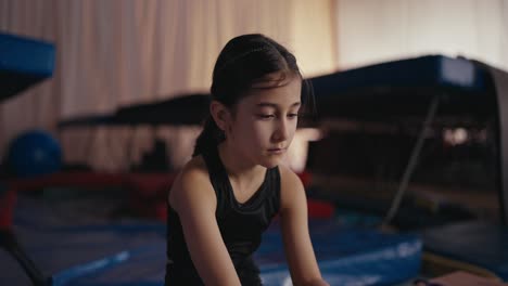 young girl gymnast training in the gym