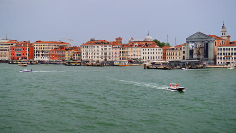 boats sailing across the canal at giudecca neighbourhood in venice, northern italy. wide shot