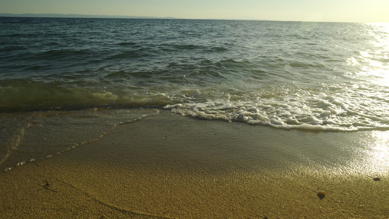 Calm Beach Waves at Sunset
