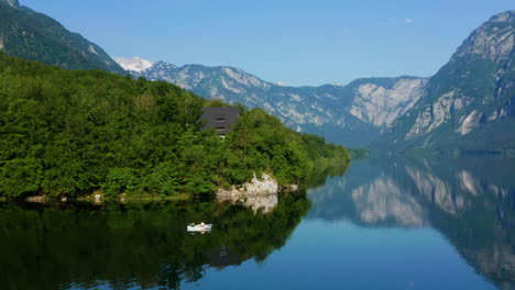 magnificent view of the mountains reflecting on lake bohinj in slovenia - aerial shot