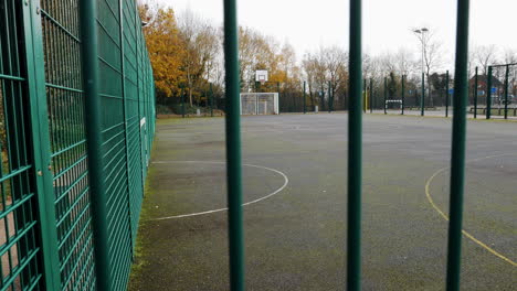 an playground featuring a basketball court and soccer pitch lies empty during the covid 19 pandemic