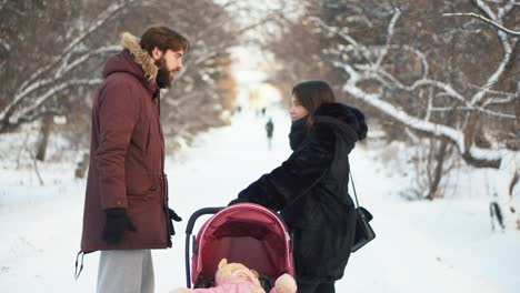 couple arguing with baby stroller in snowy park