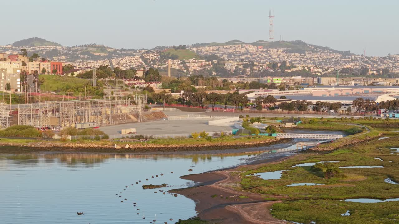 Heron’s Head Park’s pathways ripple through green fields while city life hums quietly in the distance. Aerial footage shot on a DJI Air 3S.