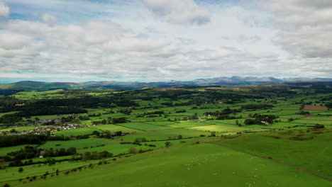 Aerial-countryside-landscape-showing-the-rural-farmland-of-the-English-Lake-District,-bright-sunny-day