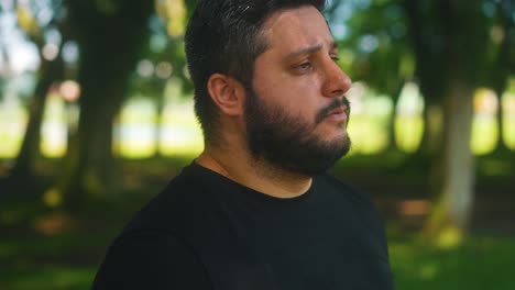 portrait orbital close up shot man drinking water after workout outdoors