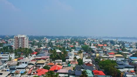 A-beautiful-aerial-view-of-Fort-Kochi,-a-developing-city-in-India-,-Kochi-backwater-and-rows-of-houses-