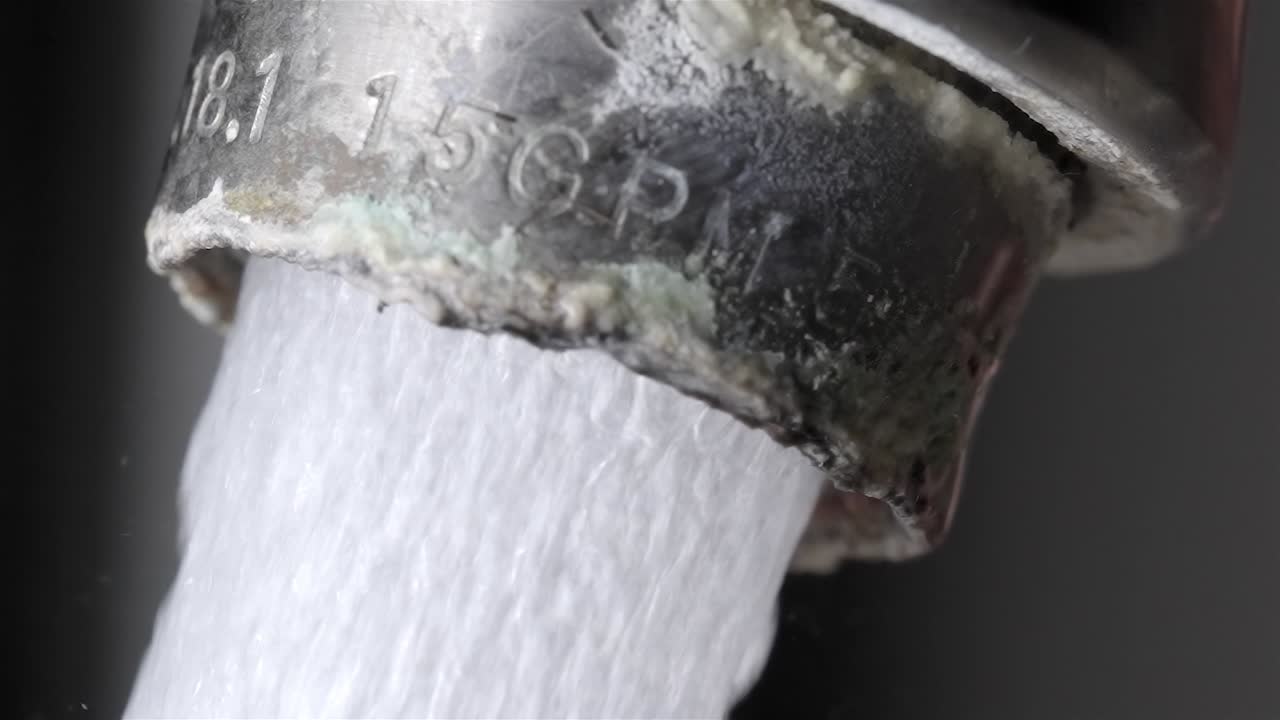 Slow Motion Close Up: Water Flowing from Dirty Limescale Faucet (240fps)