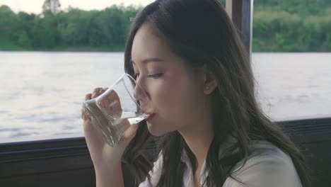 girl drinking water and looking view, video in 4k