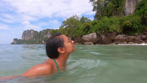 slow motion | beautiful indian girl swimming in bikini enjoying the view of beach in thailand