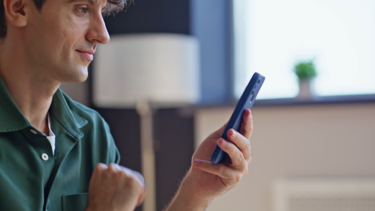 Company worker receiving notification salary at cellphone closeup. Smiling man