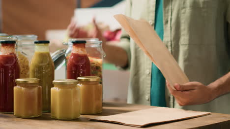 client filling in paper bag with pasta