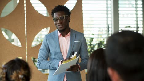 smiling manager standing and talking to coworkers