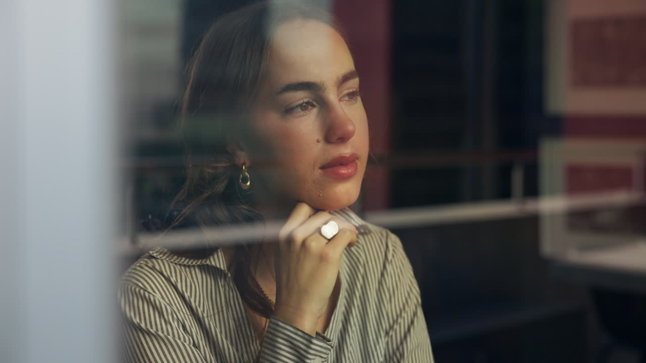 Woman gazing out of a window