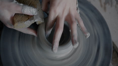 artista de cerámica trabajando en una rueda de cerámica