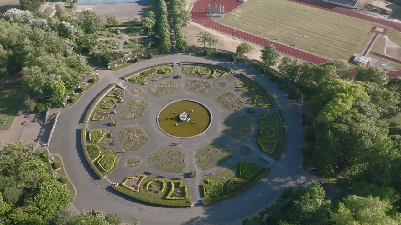 Circular Italian style gardens next to running track. Stanley Park, Blackpool, Lancashire, UK.
