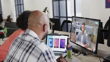 African-american-business-people-on-video-call-with-caucasian-male-colleague-on-screen