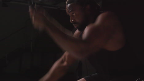 Close-Up-Studio-Shot-Of-Male-Athlete-Training-In-Fitness-Vest-Using-Battle-Ropes-Shot-Against-Black-Background-5