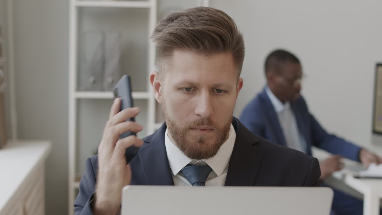 Trader Calling Investors and Working with Trading Platform om Laptop
