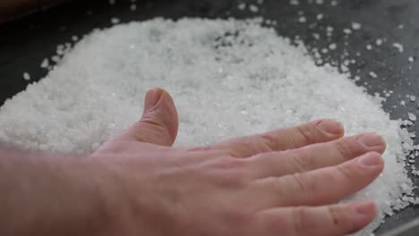 preparing a bed of salt for cooking on the grill