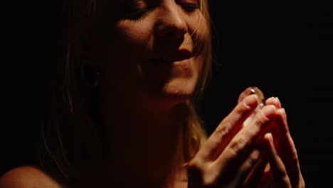 close-up of a woman with ice in dramatic lighting