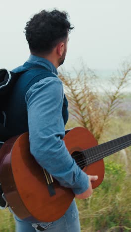 guitarist seeks inspiration with a walk by the sea