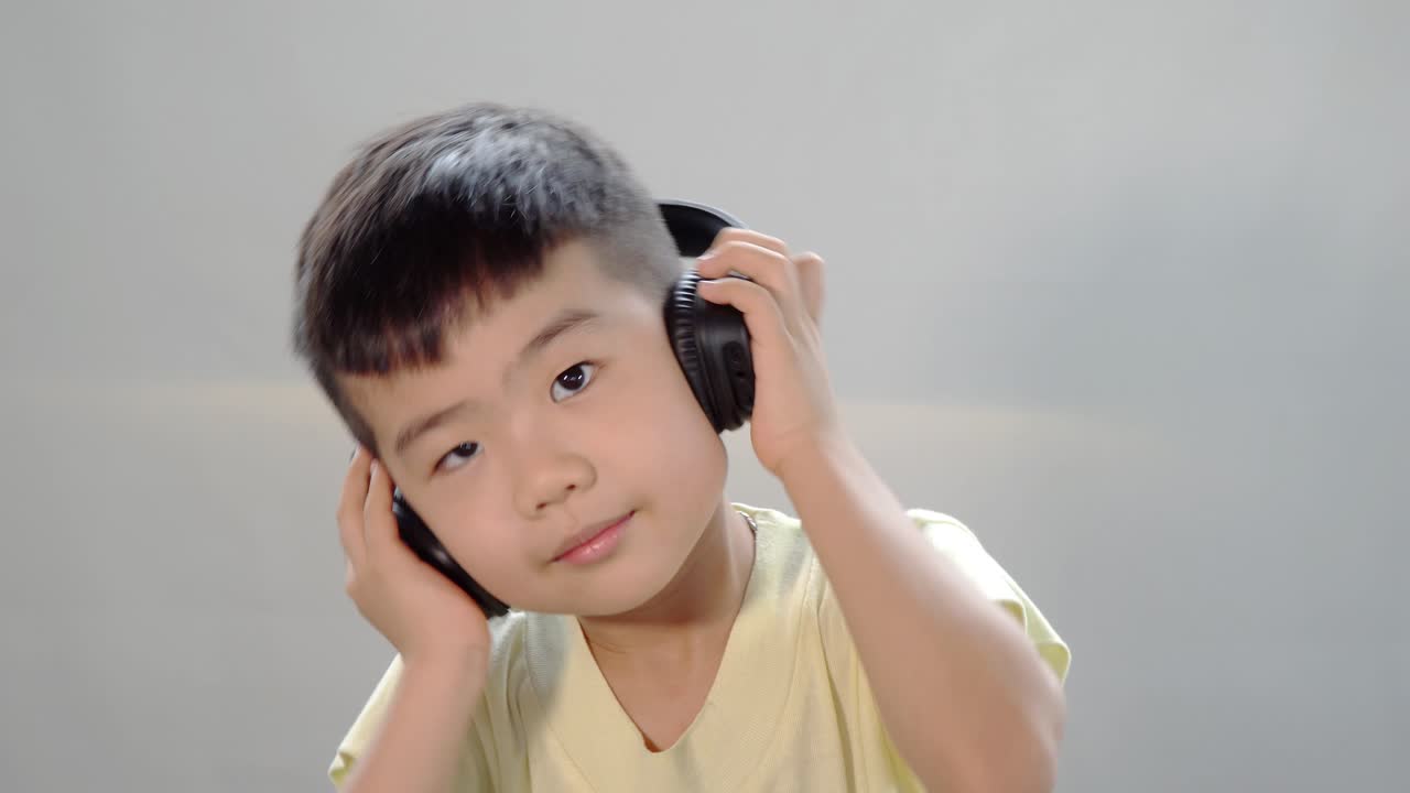 Asian Chinese Kid Listening Music With Headphone And Shake His Head Free  Stock Video Footage Download Clips