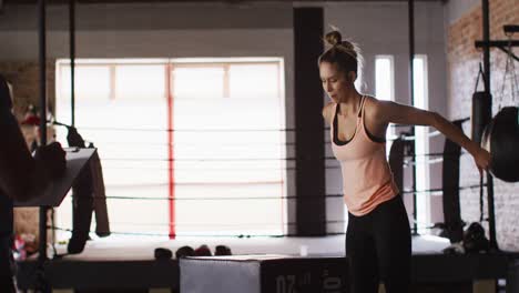 Video-of-fit-caucasian-woman-jumping-on-block-at-gym