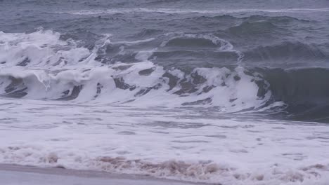 powerful ocean wave breaking off shore - slow motion