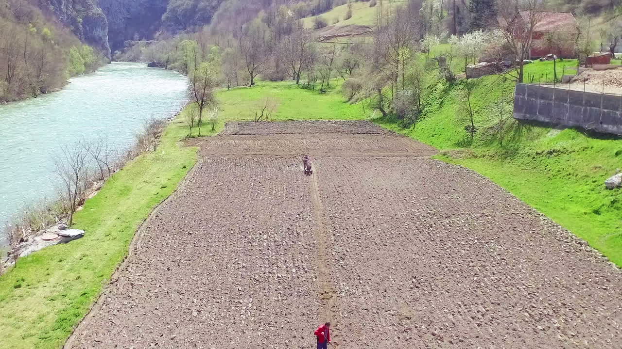 Aerial view of farmers working near the river