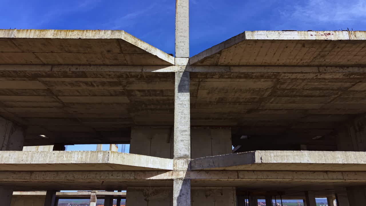 Construction of a modern building under a vibrant blue sky on a sunny day in an evolving urban landscape