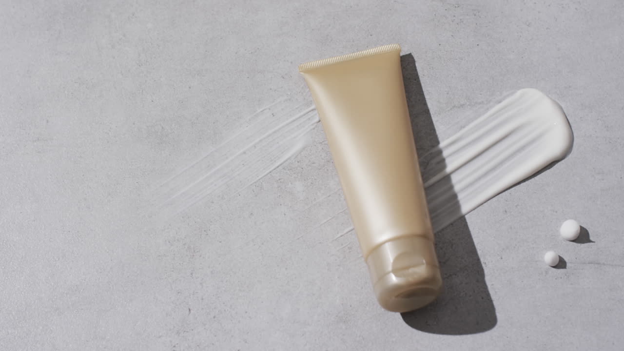 Video di tubetto di prodotto di bellezza e sbavatura di crema con spazio per il testo su sfondo bianco