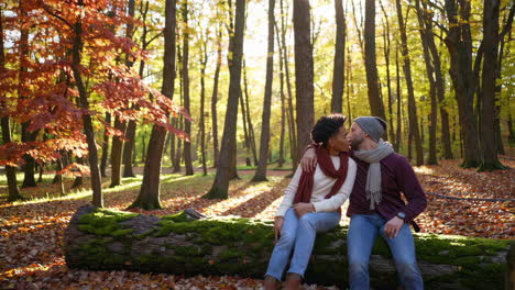 romantic couple sharing affection in autumn forest