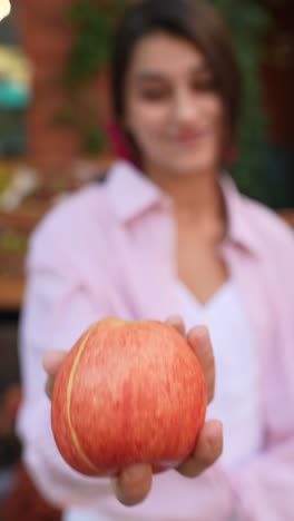 woman offering an apple