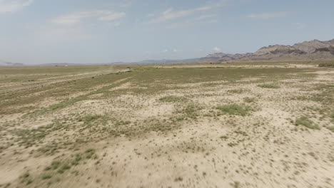 jeep cruising fast through arid steppe and leaving behind dust cloud