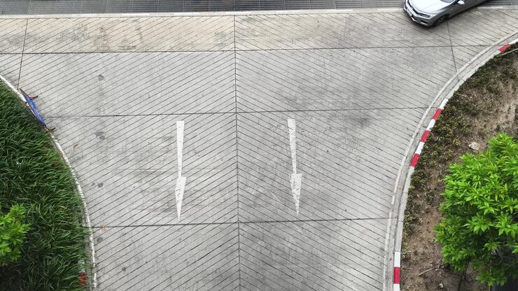 Parking Lot Intersection with Directional Arrows and Cars