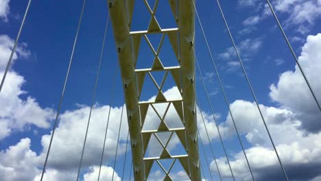 wide shot moving forward, looking up and zooming in while crossing the humber bay arch bridge