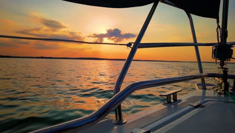 The-front-bow-of-a-white-sailing-boat-with-sunset-and-sea-background