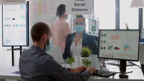 business team with protection face masks working together in company office