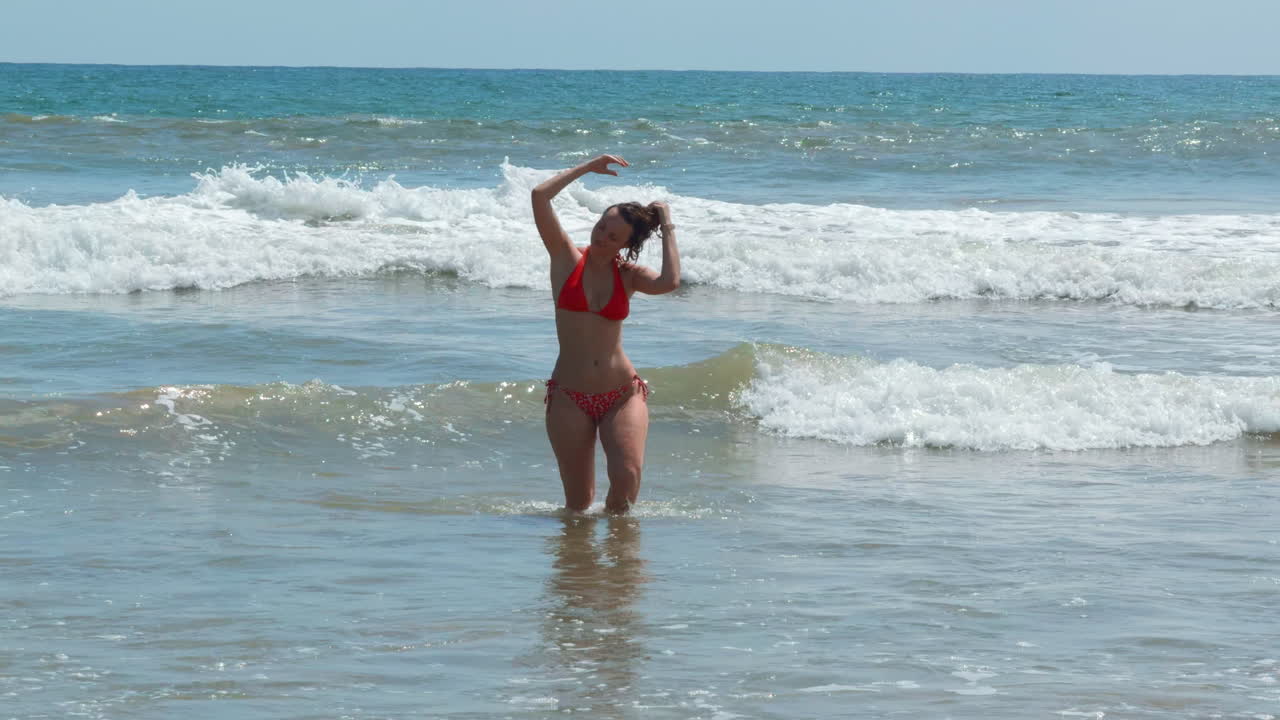 Donna in bikini rosso su una spiaggia