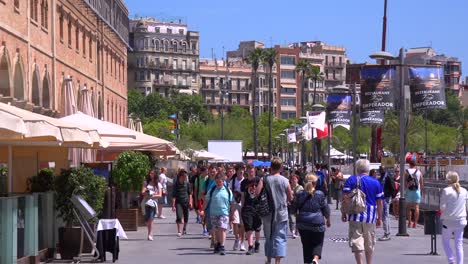 People-walk-near-the-beach-in-Barcelona-Spain