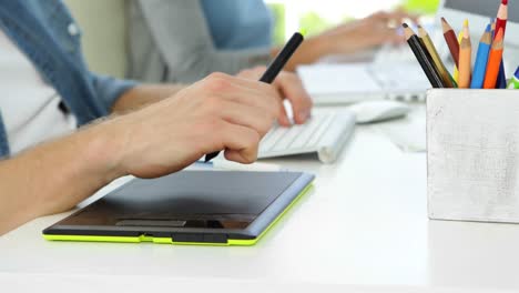 Close-up-of-young-man-working-at-his-desk-