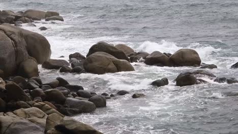 waves crashing against rocks on a rocky coast