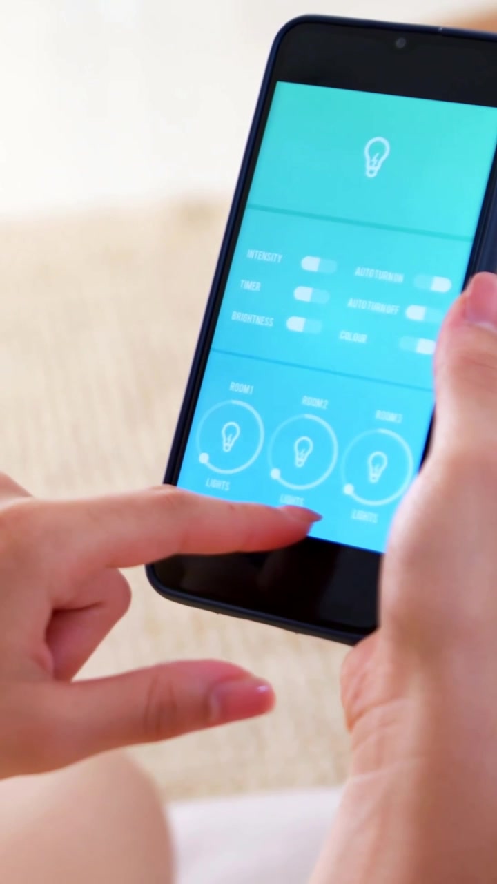 Vertical video: Tapping woman using smartphone app in blue case on couch, changing lights
